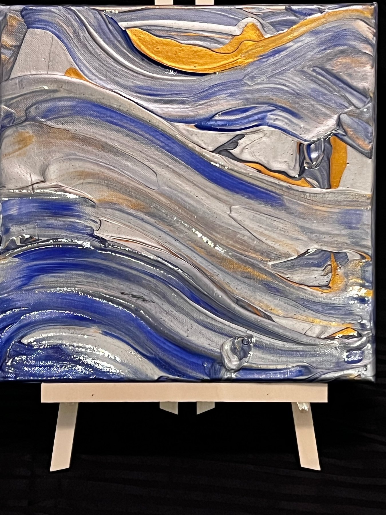 Blue gray abstract painting on an easel