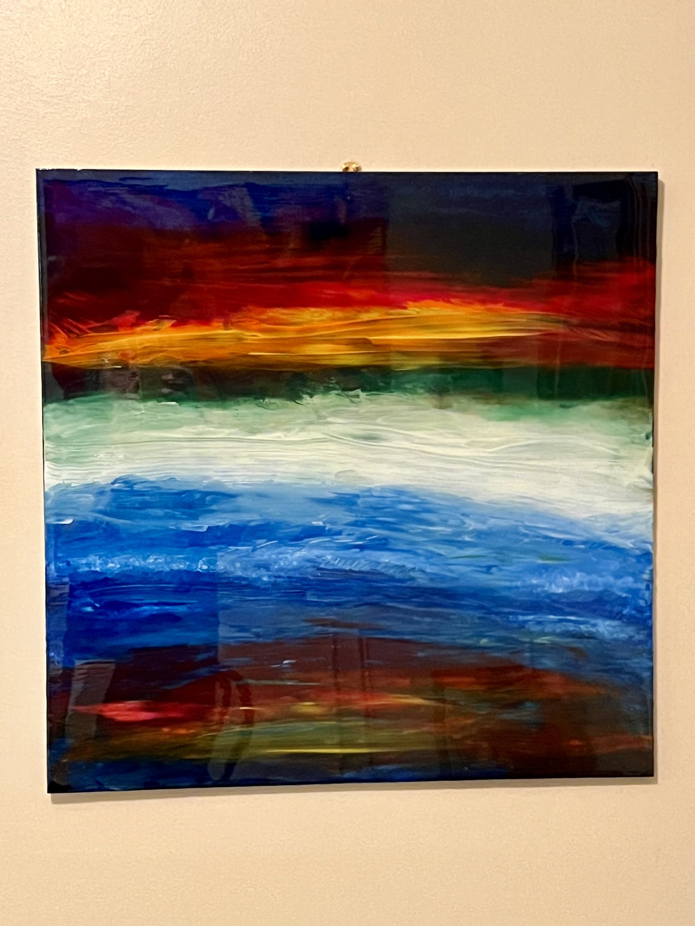 Horizontal color band painting displayed on a wall